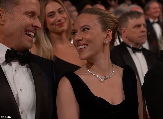 At that, the camera cut to the 40-year-old former child star, who shared a hearty laugh with her CAA agent Joe Machota (L) seated by her side