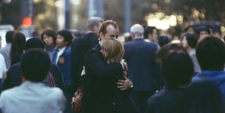 This may contain: two people hugging each other in the middle of a crowded street with text overlay This may contain: two people hugging each other in the middle of a crowded street with text overlay