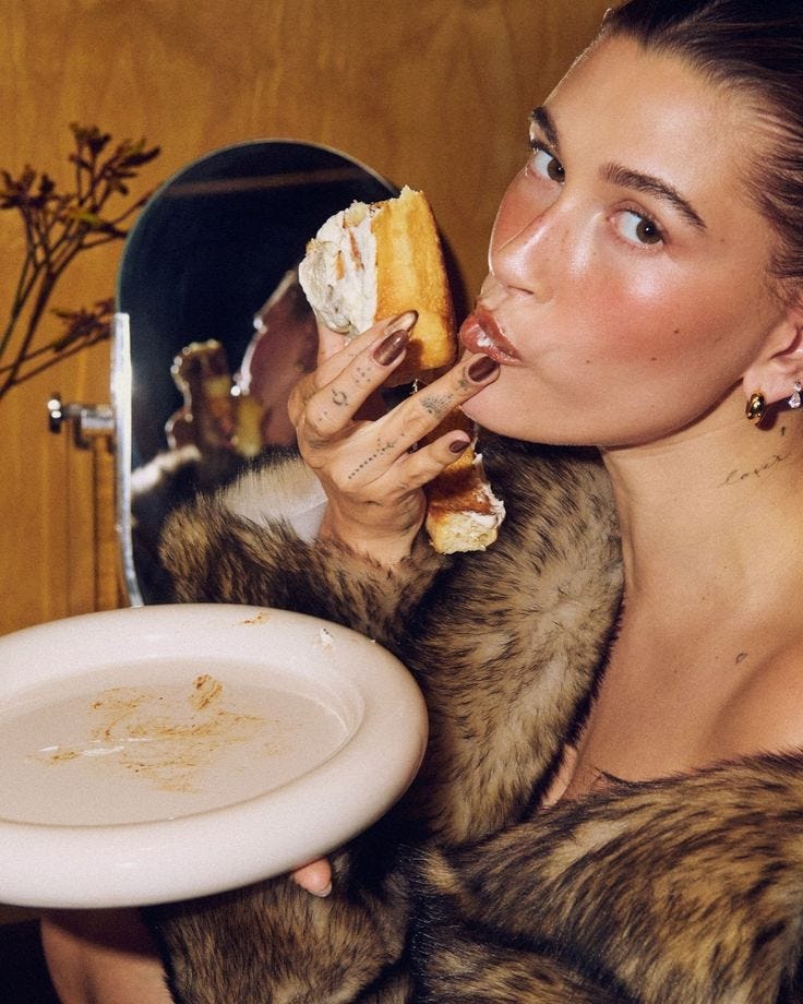 This may contain: a woman eating food in front of a mirror
