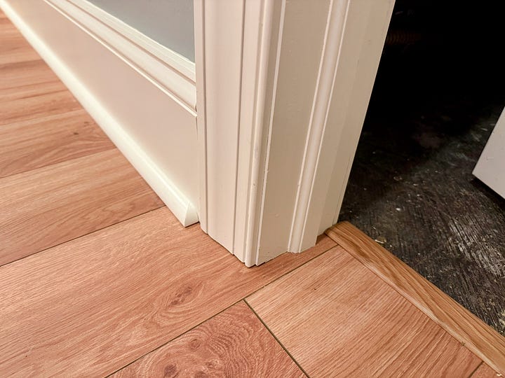 On the left, a DeWalt multitool sits on LVP. On the right, a close-up of shoe molding and a threshold finishing the edges on LVP.