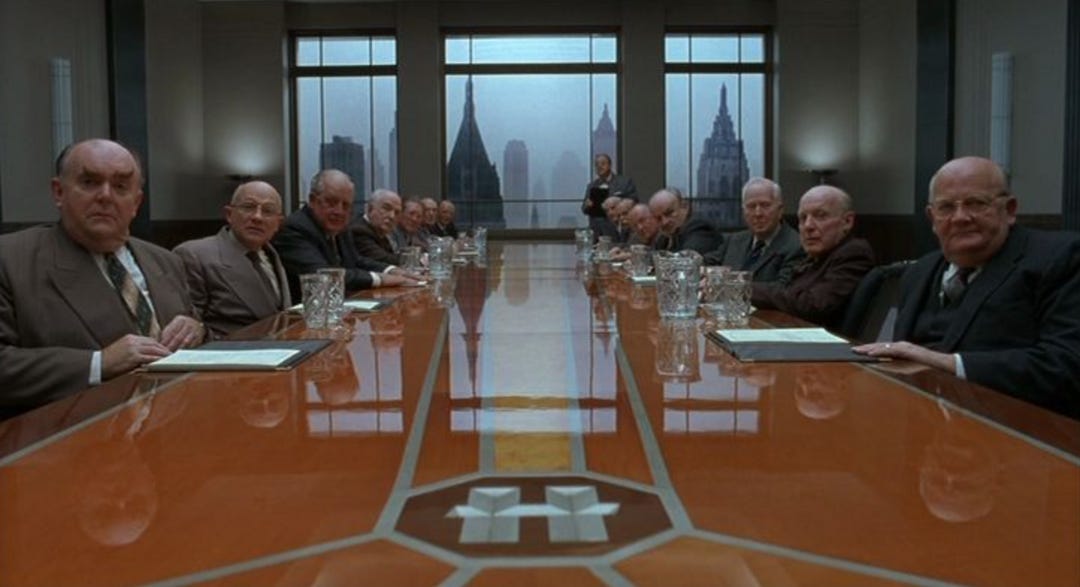 A group of men sitting at a table

AI-generated content may be incorrect.