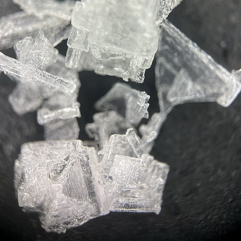 close up images of salt crystals on a black background
