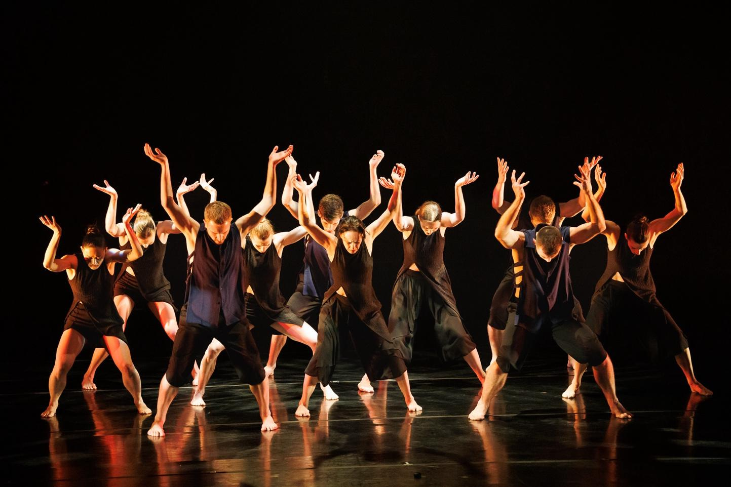 A group of people dancing on a stage

Description automatically generated