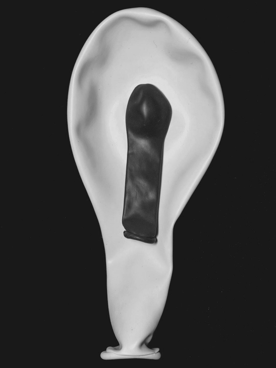 white heart shaped balloon with red paint