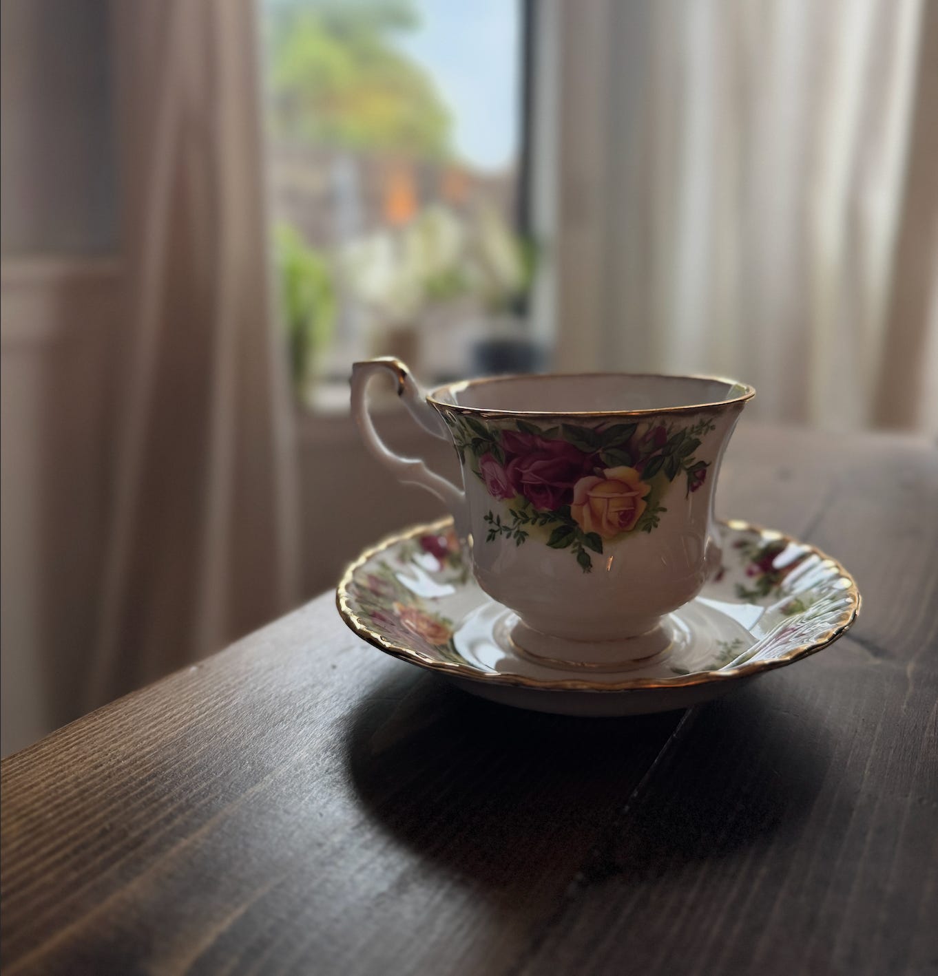 Aftershock Substack post image of grandma's china tea cup and saucer sitting on a desk while the rain came down