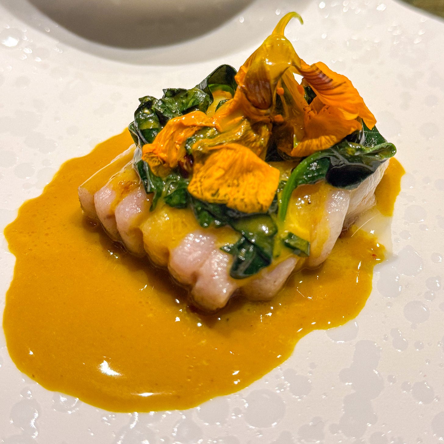 Ray with wilted spinach and herbs in golden rassam-spiced sauce at Mantra restaurant