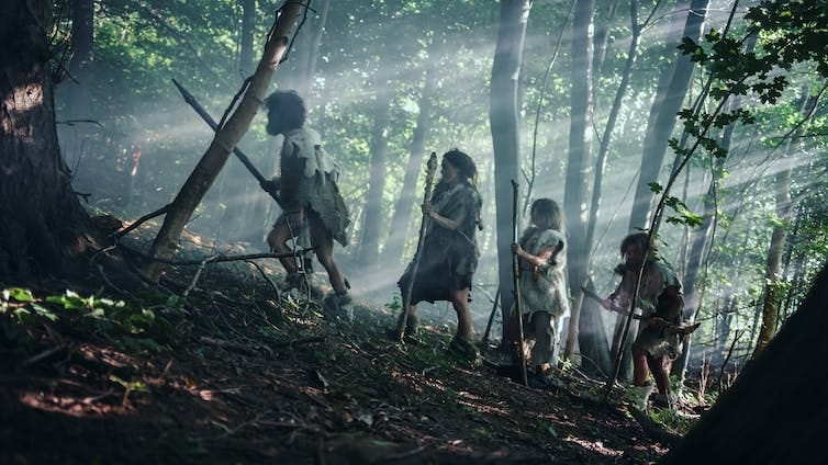 A depiction of a Neanderthal family wandering through the jungle. A depiction of a Neanderthal family wandering through the jungle.