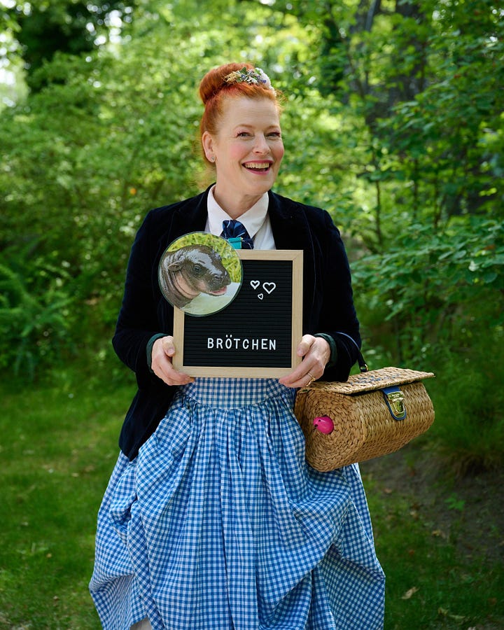 Actor in "tough guy" person with arm around actress with dyed red hair (L), and same actress smiling and holding a plaque commerating her partnership with pygmy hippo.