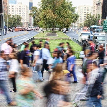 timelapse photo of people passing the street