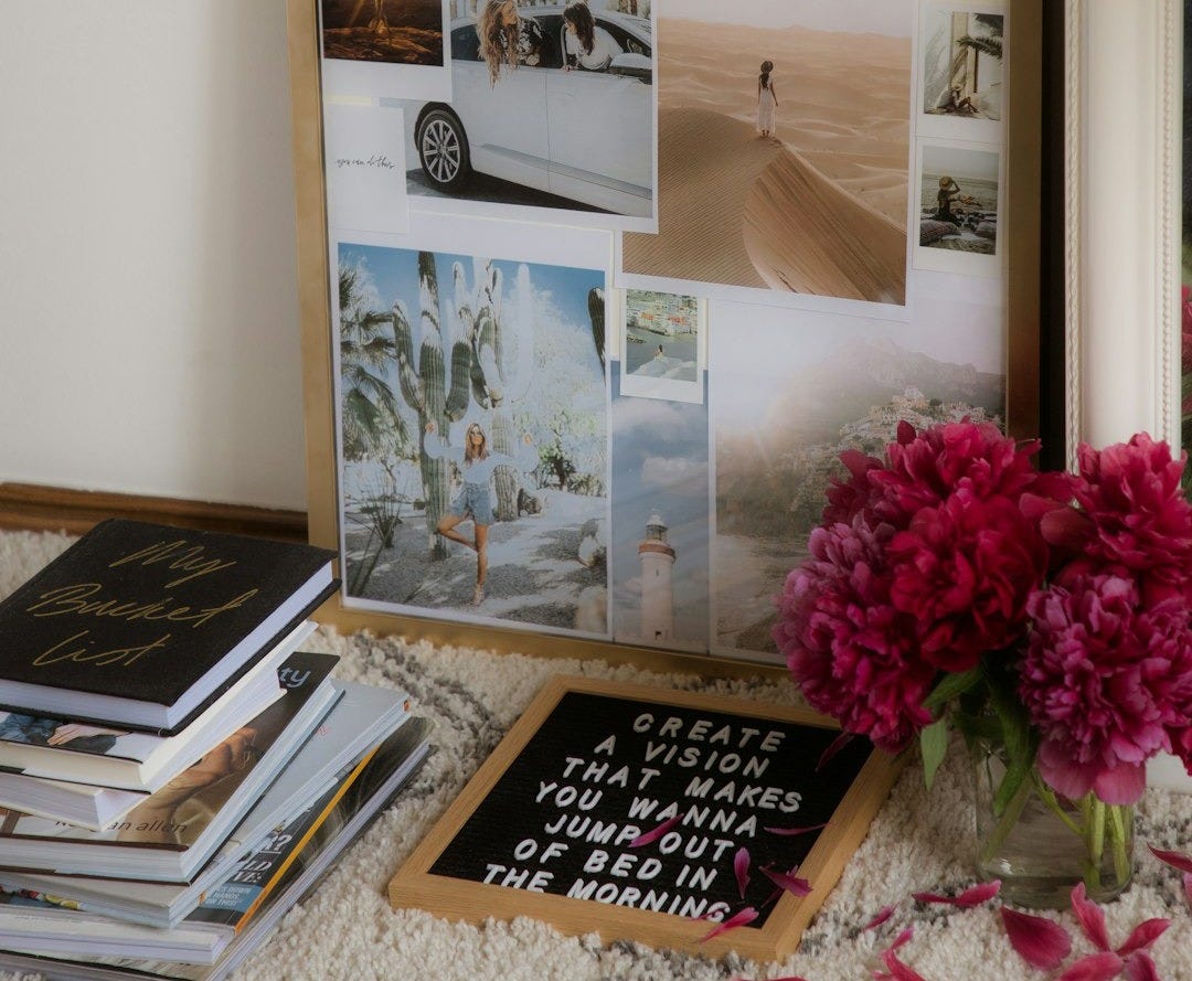 a bunch of books and a vase of flowers on a table