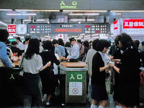 Still images from Tokyo Melody: Sakamoto playing piano, images of Tokyo subway system, street crossing, and utility workers.