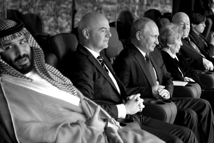 Saudi Crown Prince Mohammed bin Salman, Fifa president Gianni Infantino, and Russian President Vladimir Putin seated together in a football stadium. Saudi Crown Prince Mohammed bin Salman, Fifa president Gianni Infantino, and Russian President Vladimir Putin seated together in a football stadium.