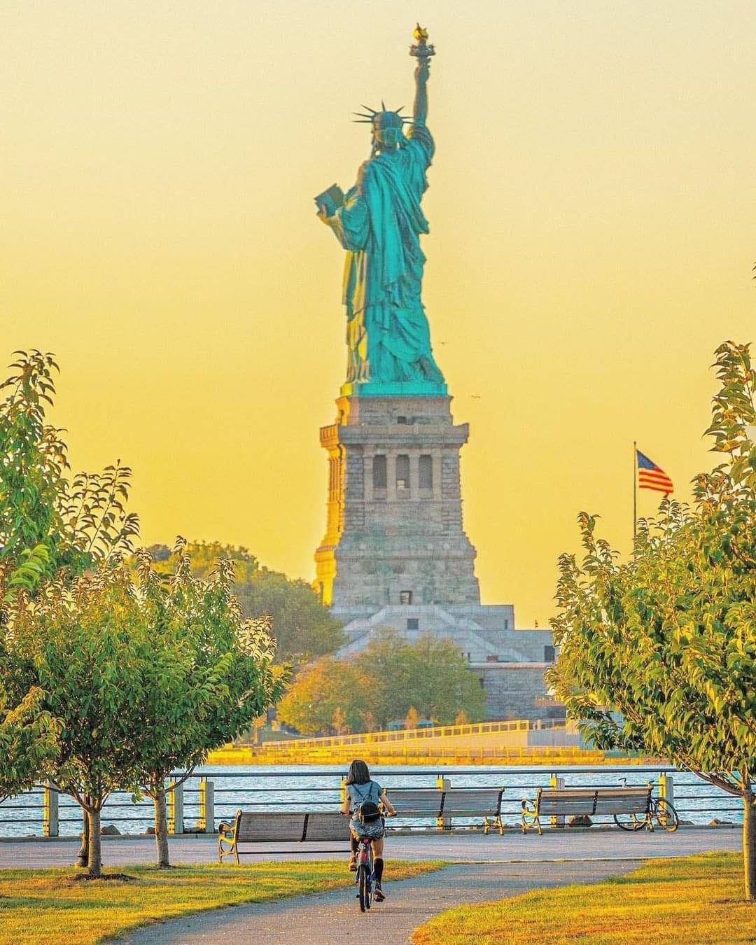 May be an image of 1 person and the Statue of Liberty