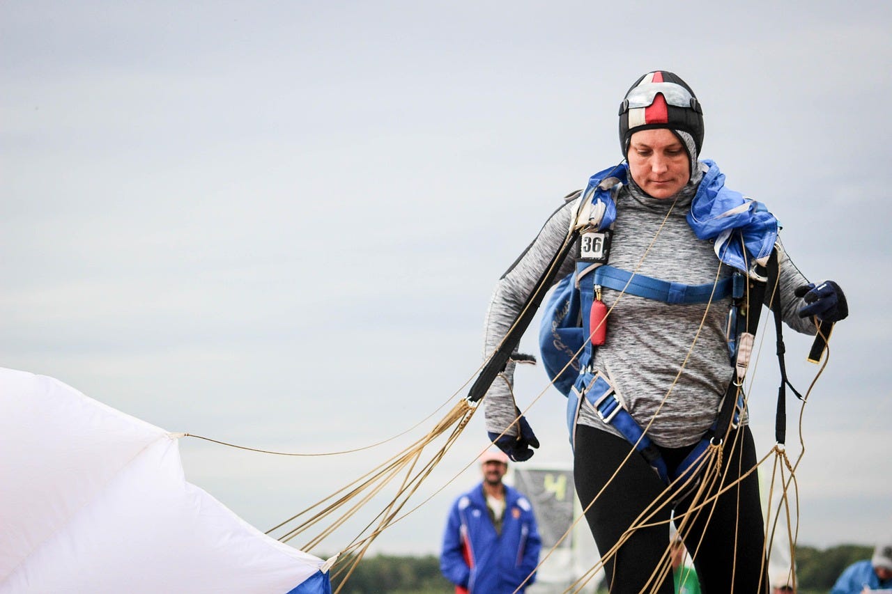 woman landing a parachute jump safely (substack hero page)