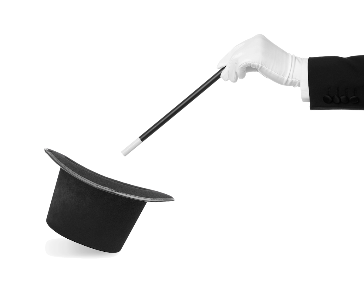 Magician's arm and stick pointing down into magician's hathat Magician's arm and stick pointing down into magician's hathat