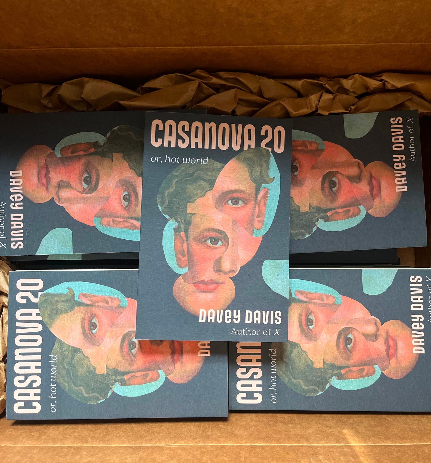 An open cardboard box full of copies of "Casanova"