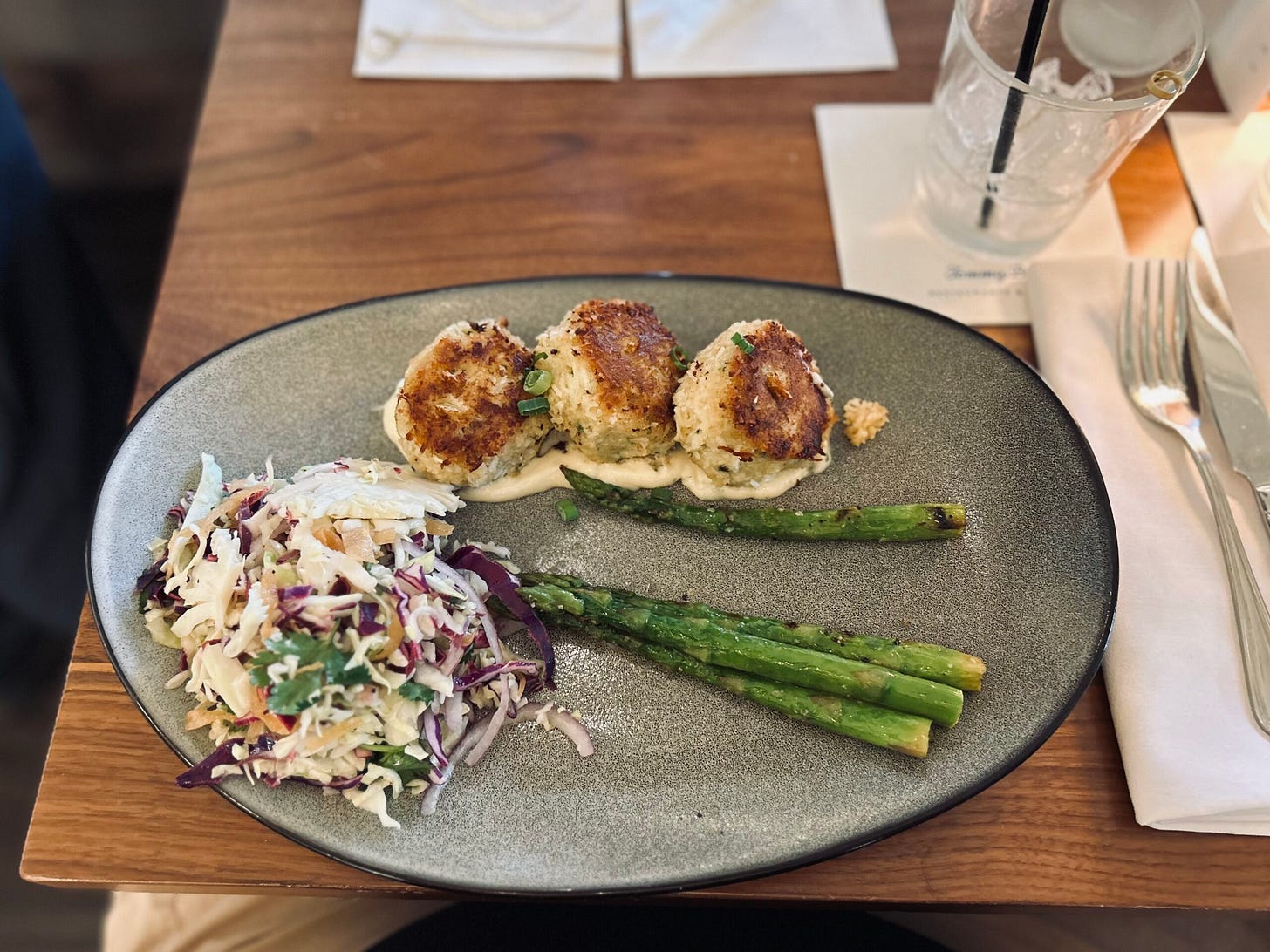 crab cakes, asparagus, cole slaw, plate, utensils, table