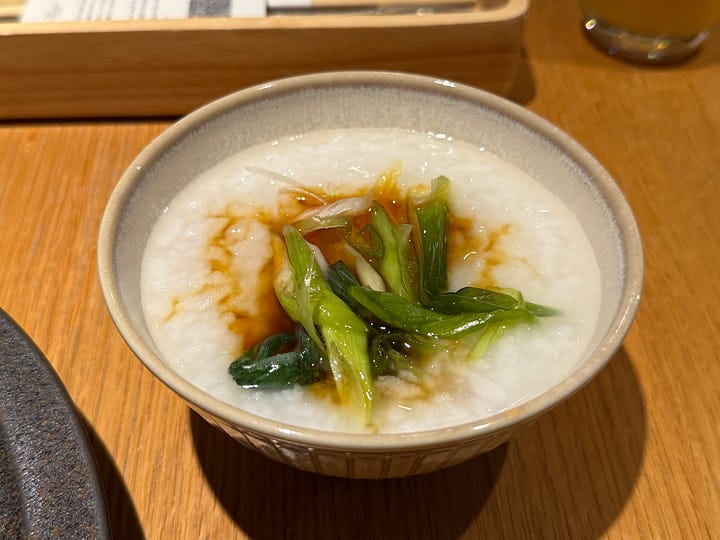 Four images of a traditional Korean and Japanese breakfast spread — grilled mackerel, rice congee with scallions, an assortment of banchan side dishes, and miso soup with tofu.