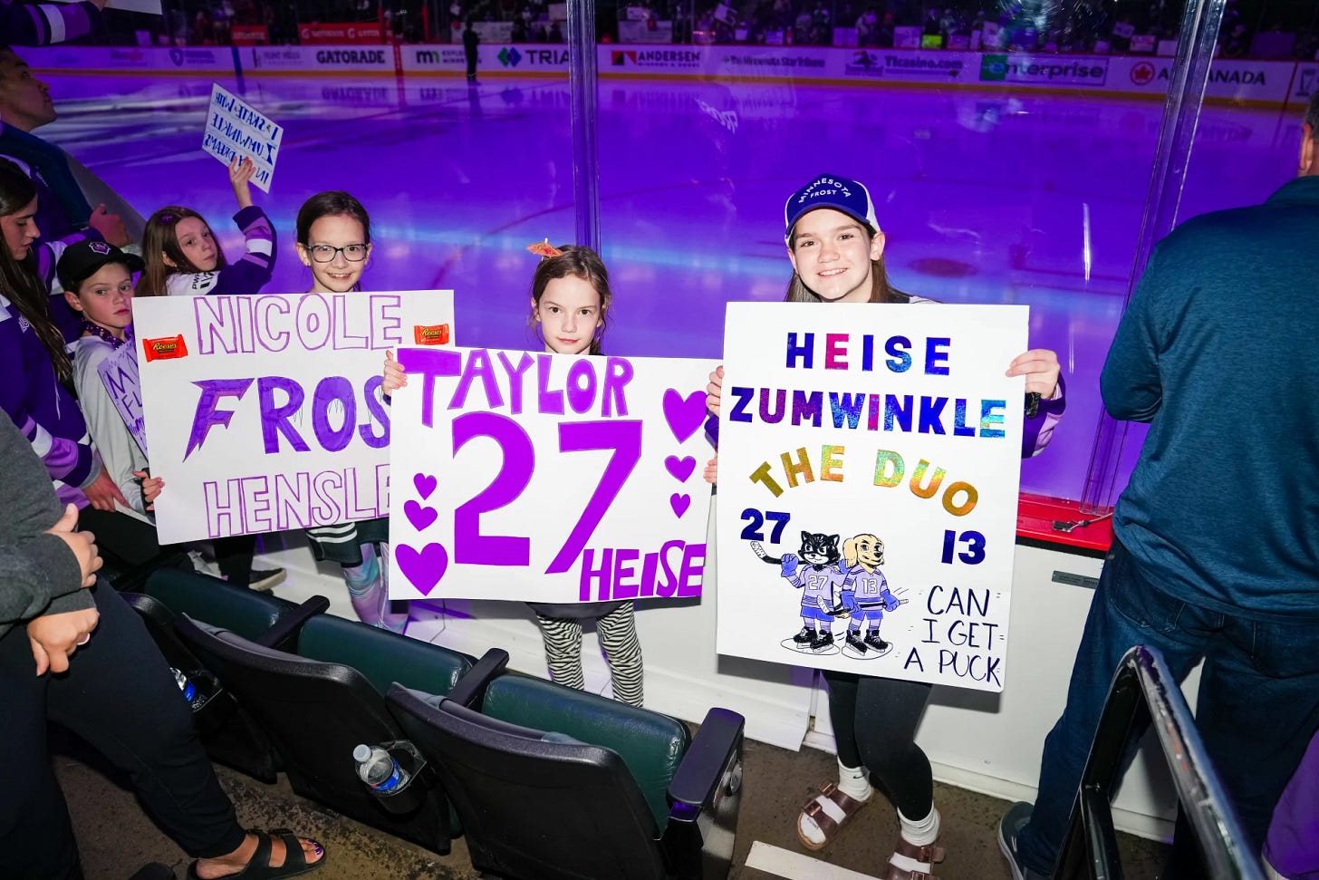 Girls with signs for Hensley, Heise, and Zumwinkle.