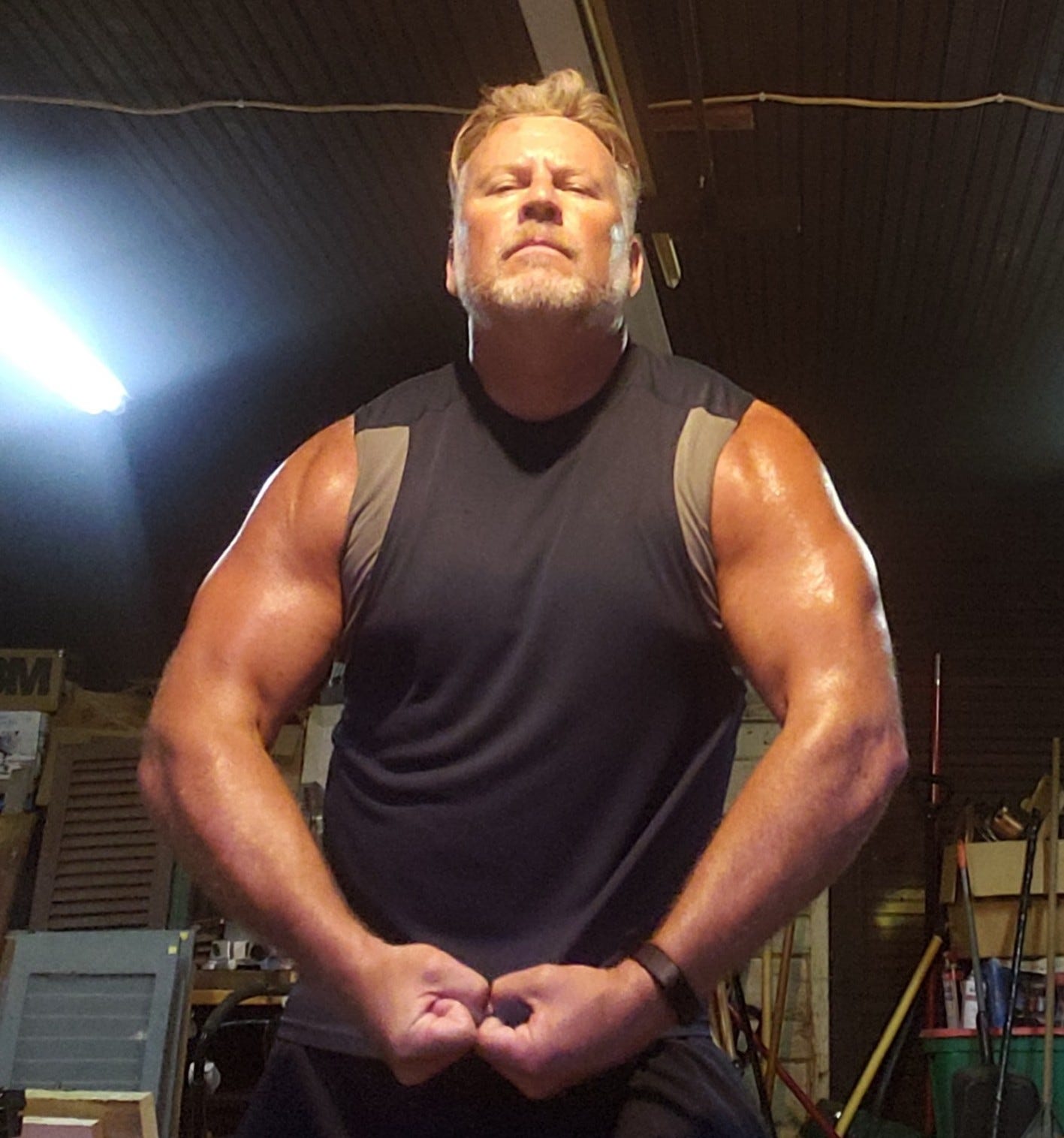 A bodybuilding man flexing his muscles in front of himself A bodybuilding man flexing his muscles in front of himself