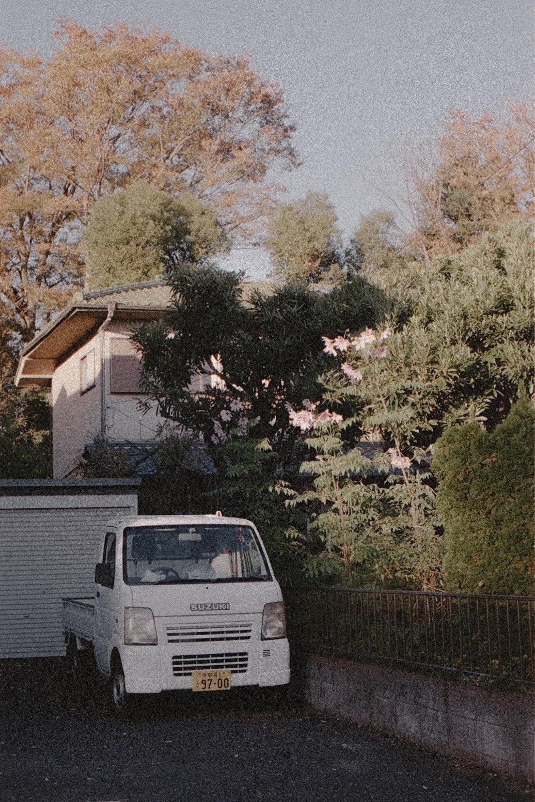 Tiny car, parked in cute company of a fall coloured Japan.