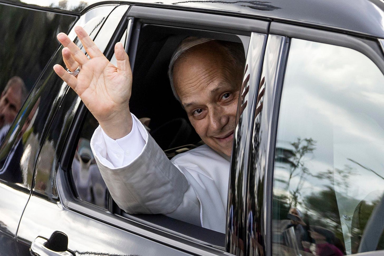 Pope Leo XIV smiles and waves from the rear window of a car as he leaves Gemelli Hospital in Rome Pope Leo XIV smiles and waves from the rear window of a car as he leaves Gemelli Hospital in Rome