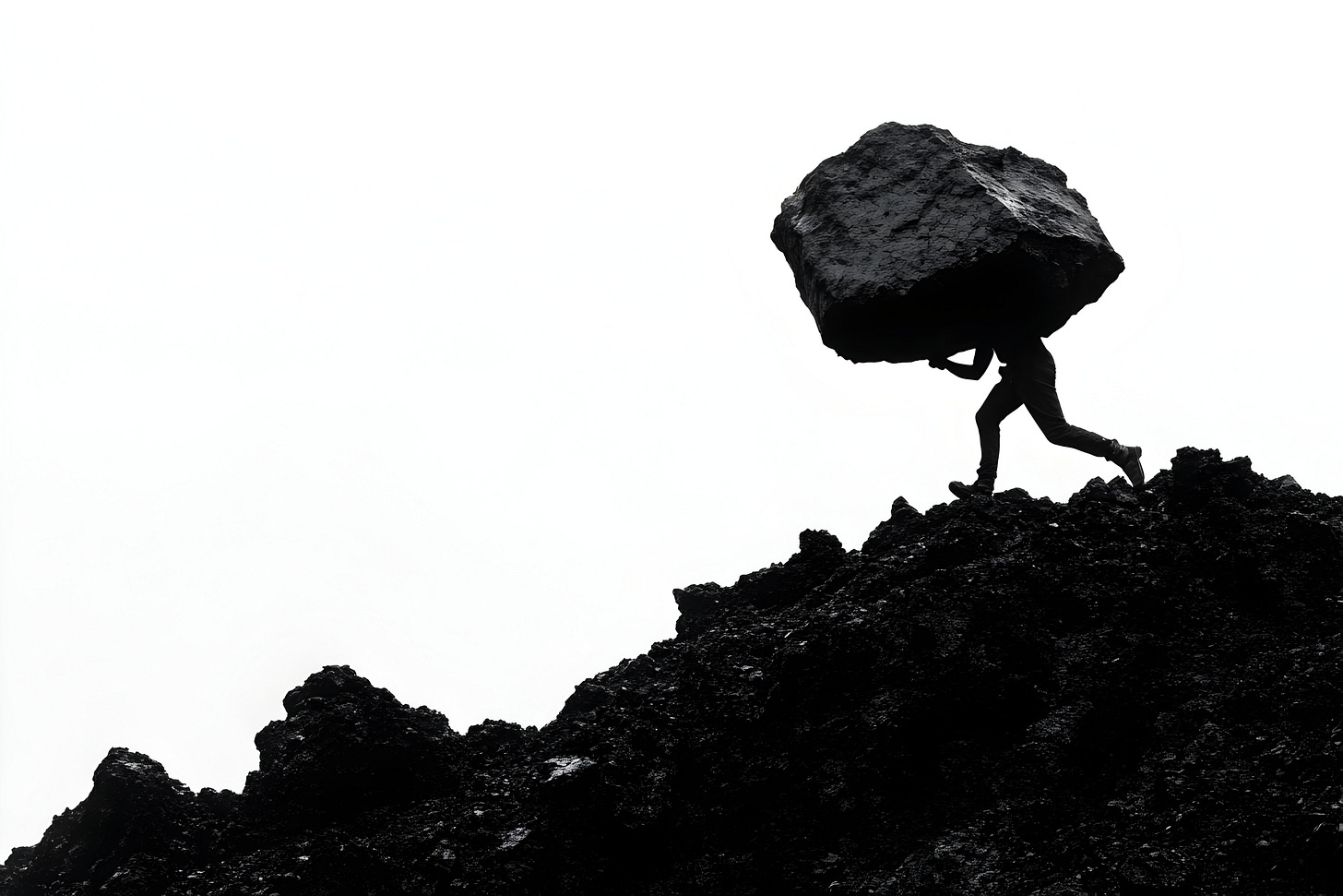 Silhouette of a person carrying a huge boulder uphill