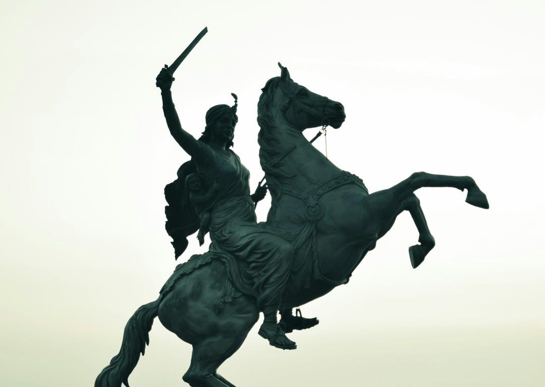 a statue of a man riding on the back of a horse a statue of a man riding on the back of a horse