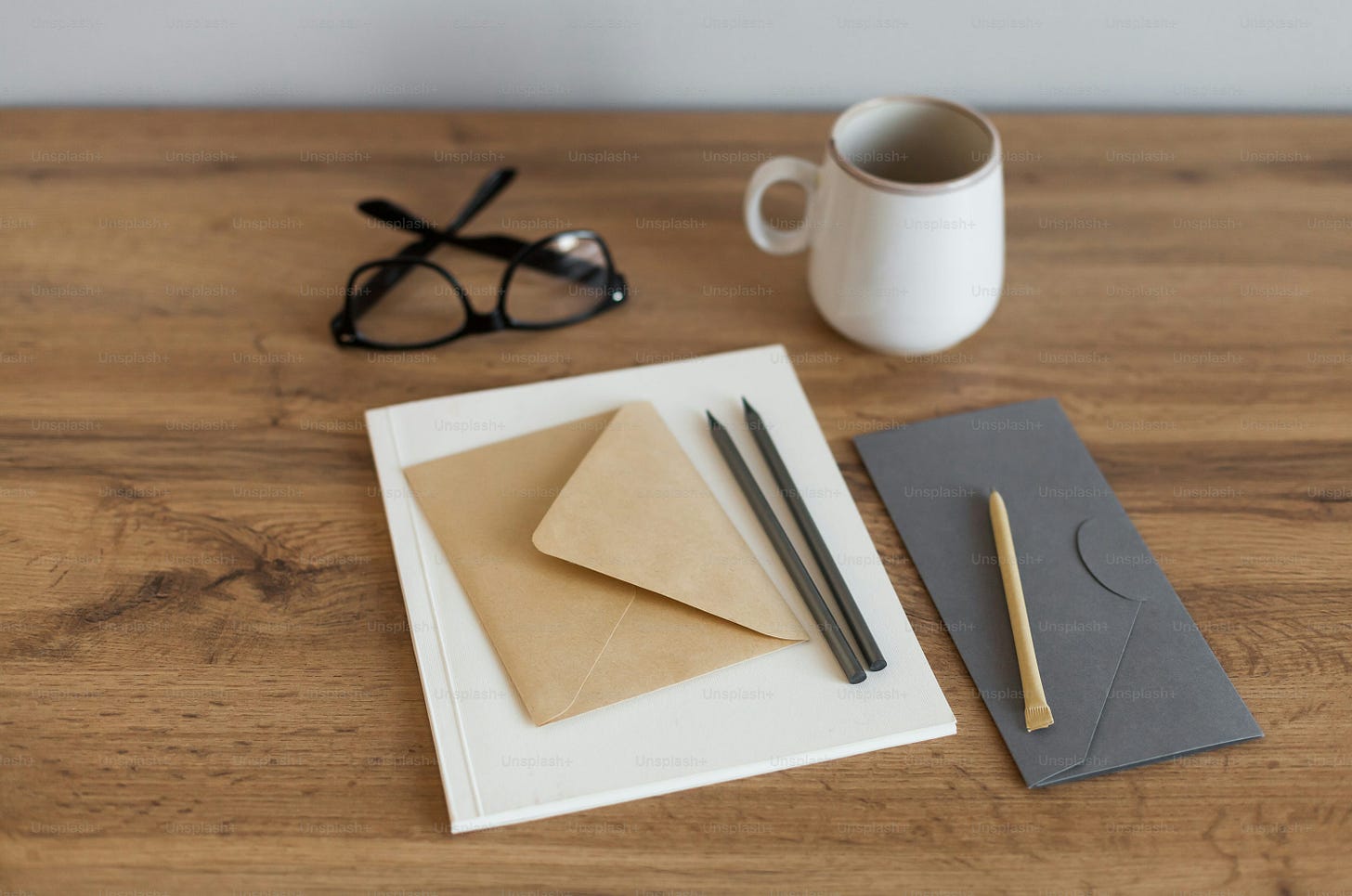 a cup of coffee and a pair of glasses on a table