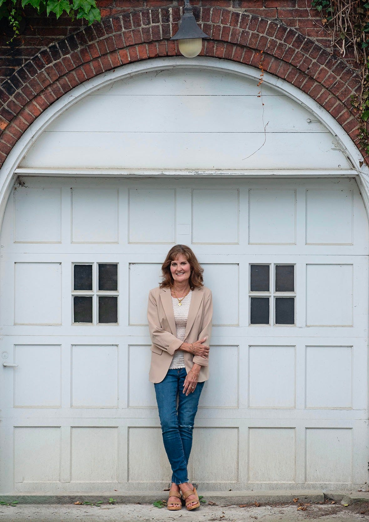 Author leaning against a white garage door