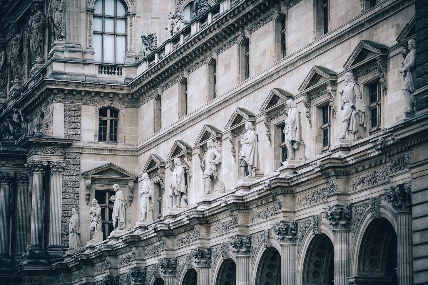 a large building with statues on the side of it