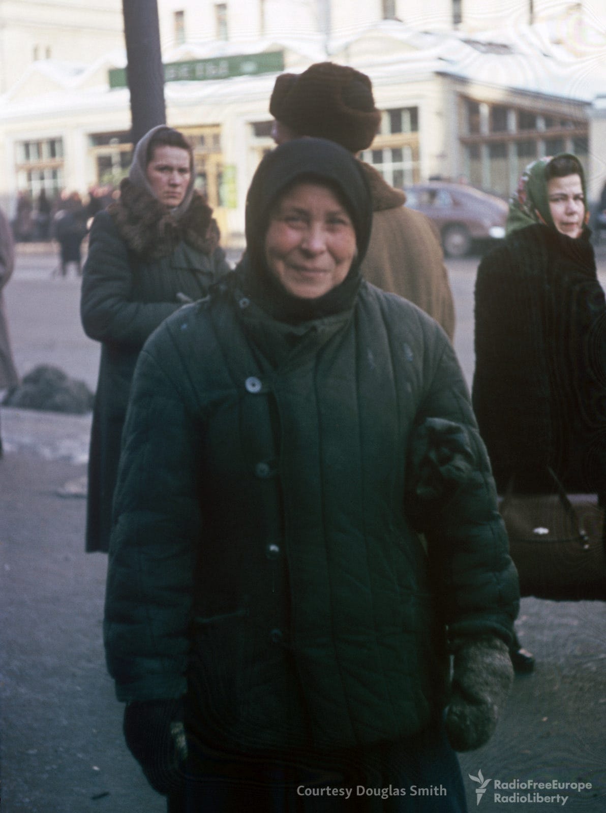 A striking portrait of a woman posing elegantly opposite 14 Petrovka ulitsa, Moscow, reflecting individual style in the 1950s. A striking portrait of a woman posing elegantly opposite 14 Petrovka ulitsa, Moscow, reflecting individual style in the 1950s.