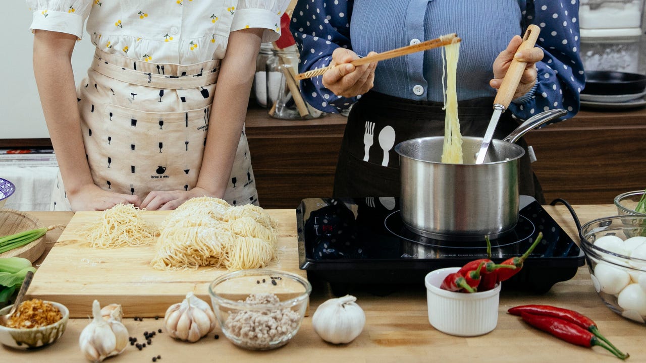 Two women cooking a meal at home.