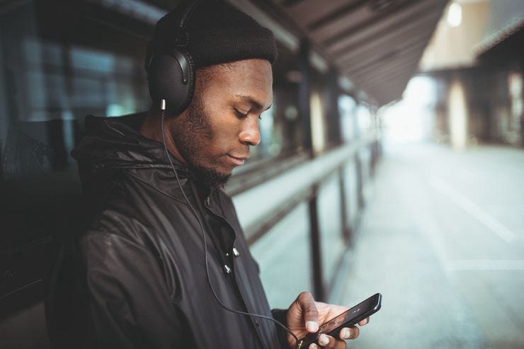 105948202 1559656491310man is listening to music with his smartphone t20 vk06jl 105948202 1559656491310man is listening to music with his smartphone t20 vk06jl