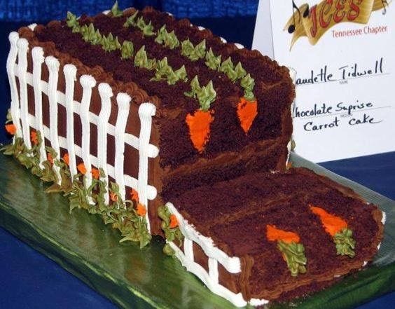 This may contain: a chocolate cake with carrots on it sitting next to a business card and sign