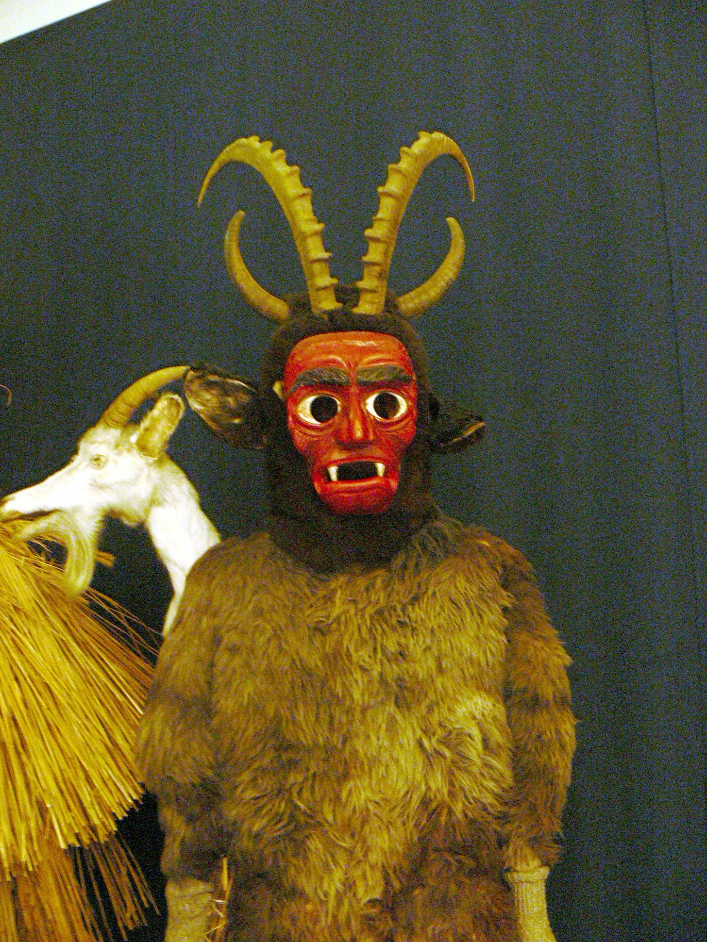 A carved wooden Krampus mask from Bad Mitterndorf, made about 1950, photographed in the collection of Schloss Trautenfels. A carved wooden Krampus mask from Bad Mitterndorf, made about 1950, photographed in the collection of Schloss Trautenfels.