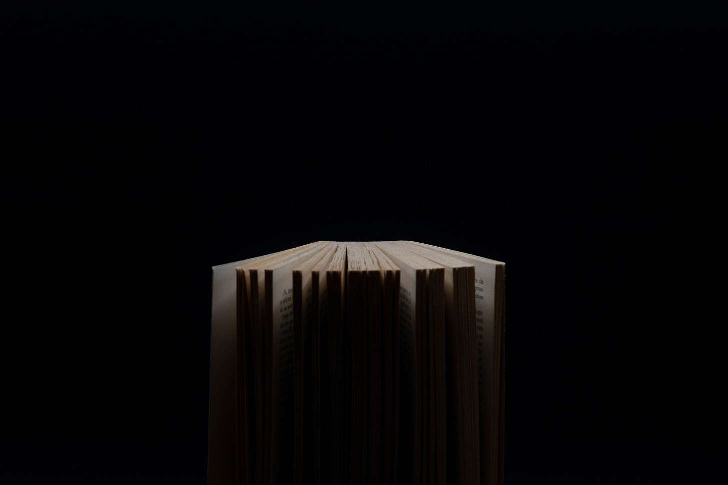 An open book in a black space. An open book in a black space.