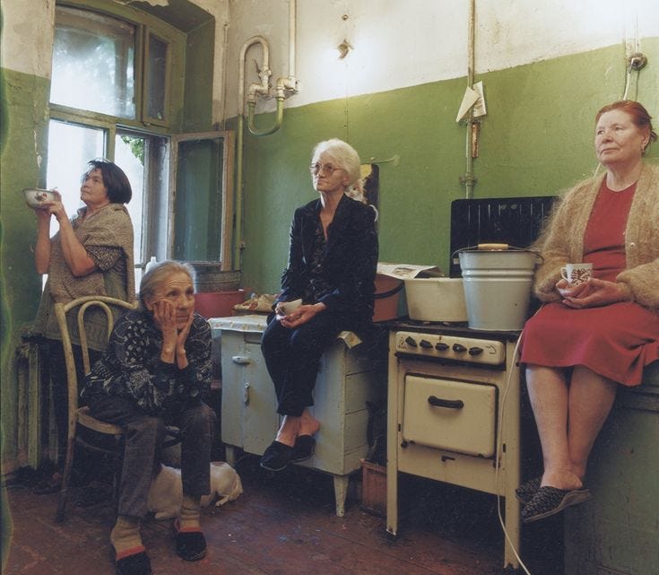 This may contain: three women are sitting in the kitchen with pots and pans