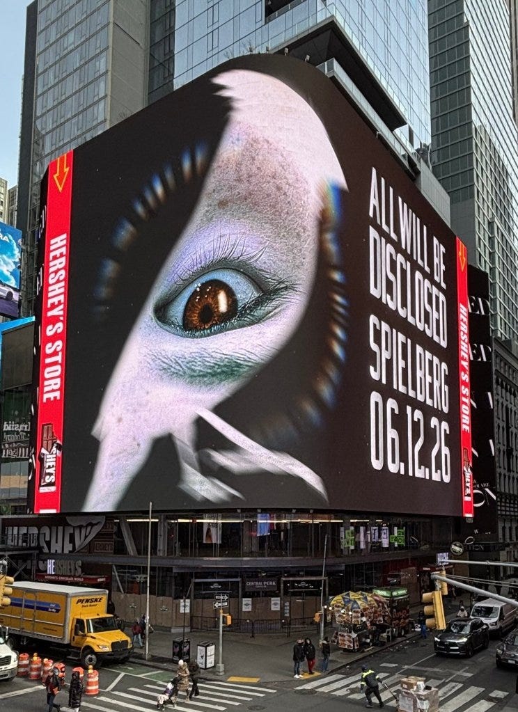 A billboard in Times Square showing a close-up of an eye with "ALL WILL BE DISCLOSED SPIELBERG 06.12.26" A billboard in Times Square showing a close-up of an eye with "ALL WILL BE DISCLOSED SPIELBERG 06.12.26"