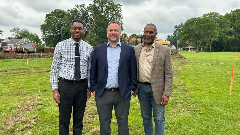 Warren Councilman Todd Johnson, D-1st; Matt Martin, executive director of Trumbull Neighborhood Partnership; and Warren Mayor Doug Franklin pose Tuesday morning at a ceremonial groundbreaking for four single-family homes being built where Emerson Elementary School was.