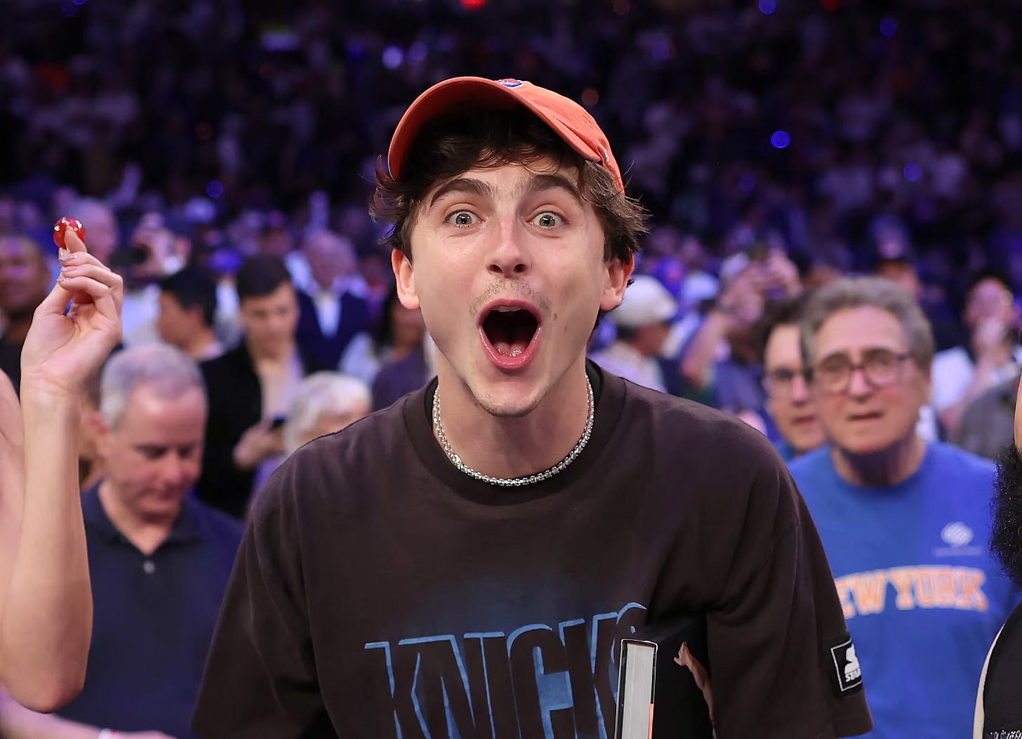 Timmy looking shocked and happy in a Knicks t-shirt.