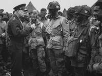 General Dwight Eisenhower, Supreme Commander in Europe, talks with paratroopers shortly before the Normandy invasion, June 6, 1944.