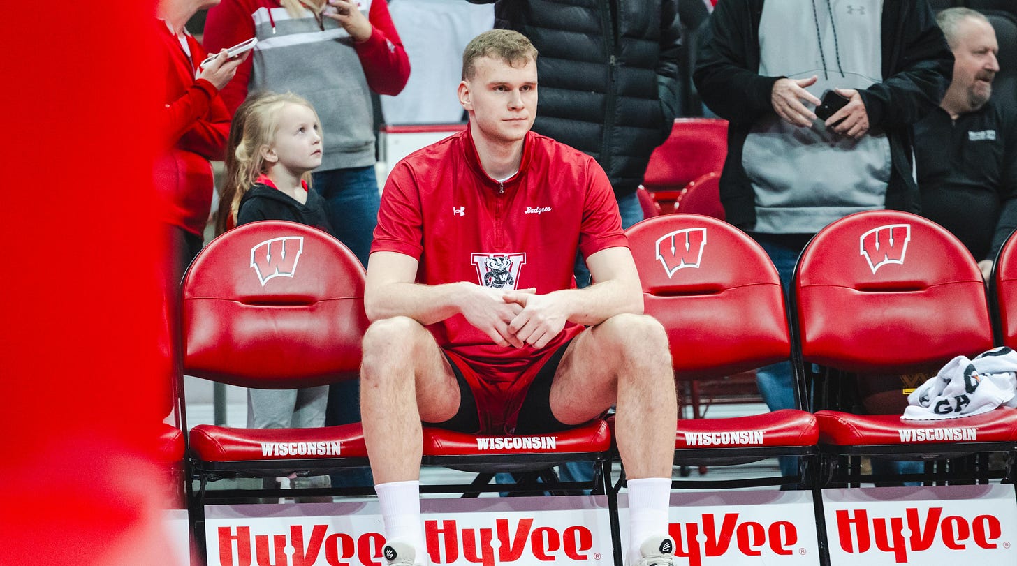 Aleksas Bieliauskas sitting on the bench during a Wisconsin Badgers men’s basketball game, photo by Dane Sheehan