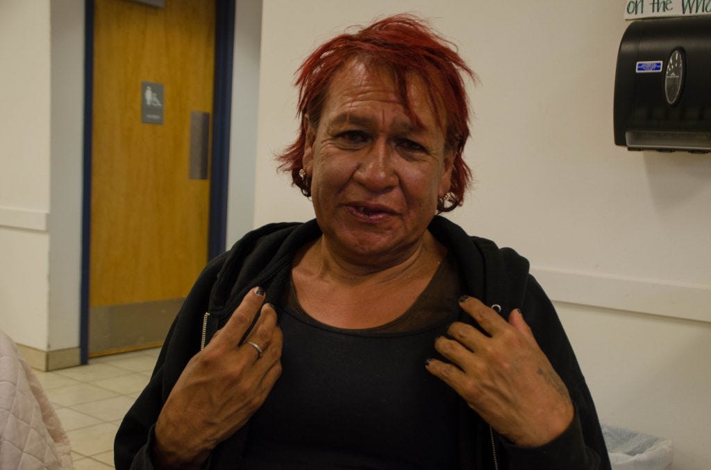"Jamie", one of those who has come to the shelter for a meal, shows off his nails, which he has painstakingly painted.