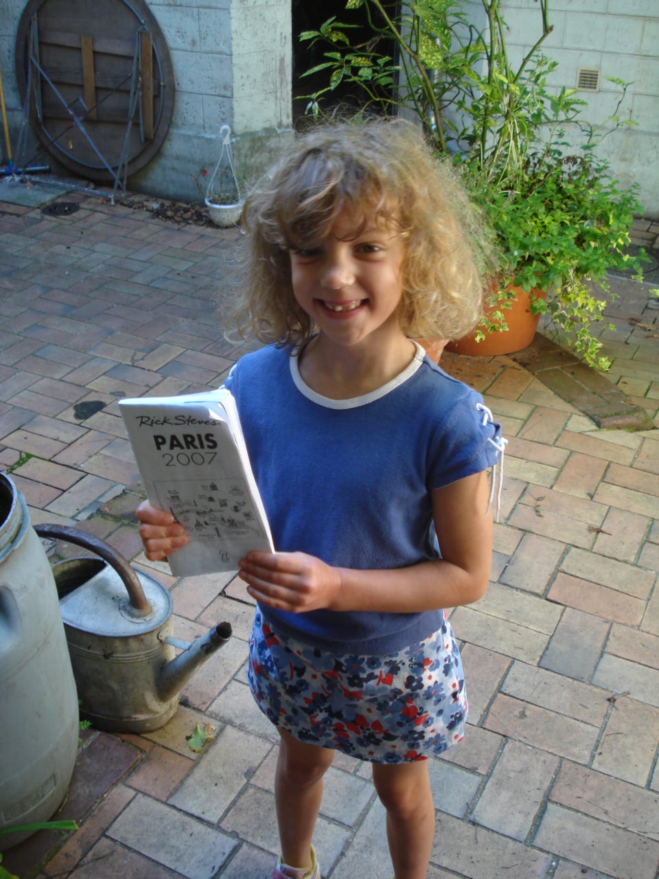 Our daughter Kelly holding some torn out pages from a Rick Steves guidebook in 2007