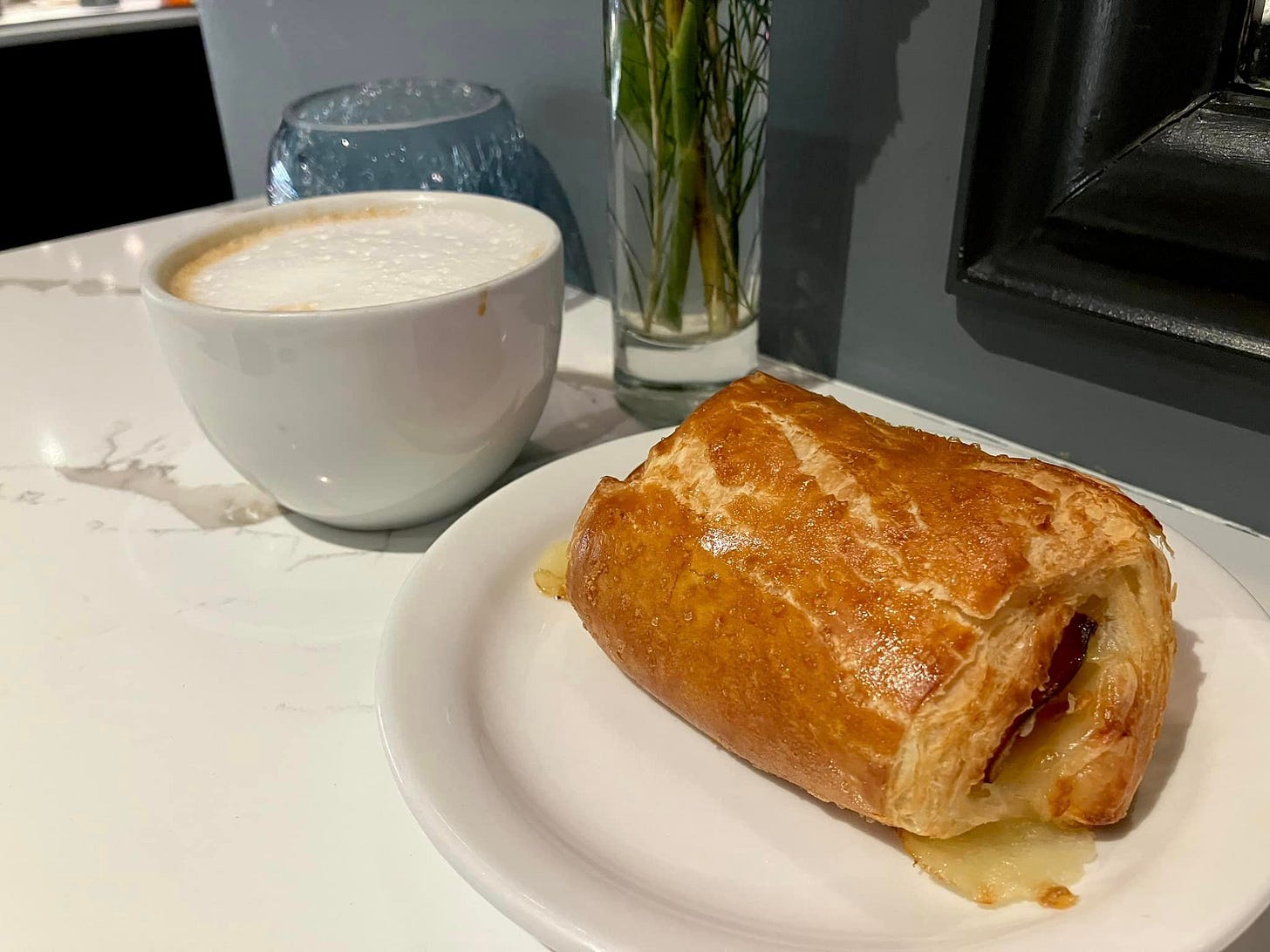 May be an image of baguette, babka, coffee, cinnamon roll, turnover and tart