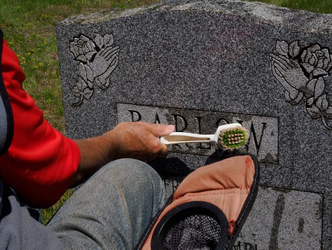 Carl cleaning gravestones