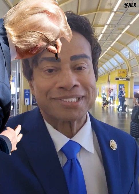 A digitally altered image of Donald Trump with his hair superimposed on another man\'s head, wearing a blue suit, white shirt, and blue tie. The man has exaggerated eyebrows drawn on his face. The background shows an indoor walkway with yellow walls, a ceiling with lights, and people walking. A watermark "@ALX" is visible in the top right corner.