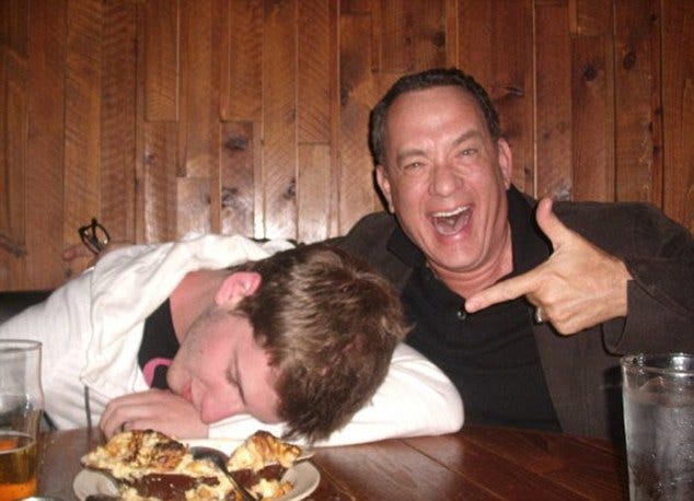 So two guys go into a bar: Tom Hanks hams it up for the camera with a fan in North Dakota last week