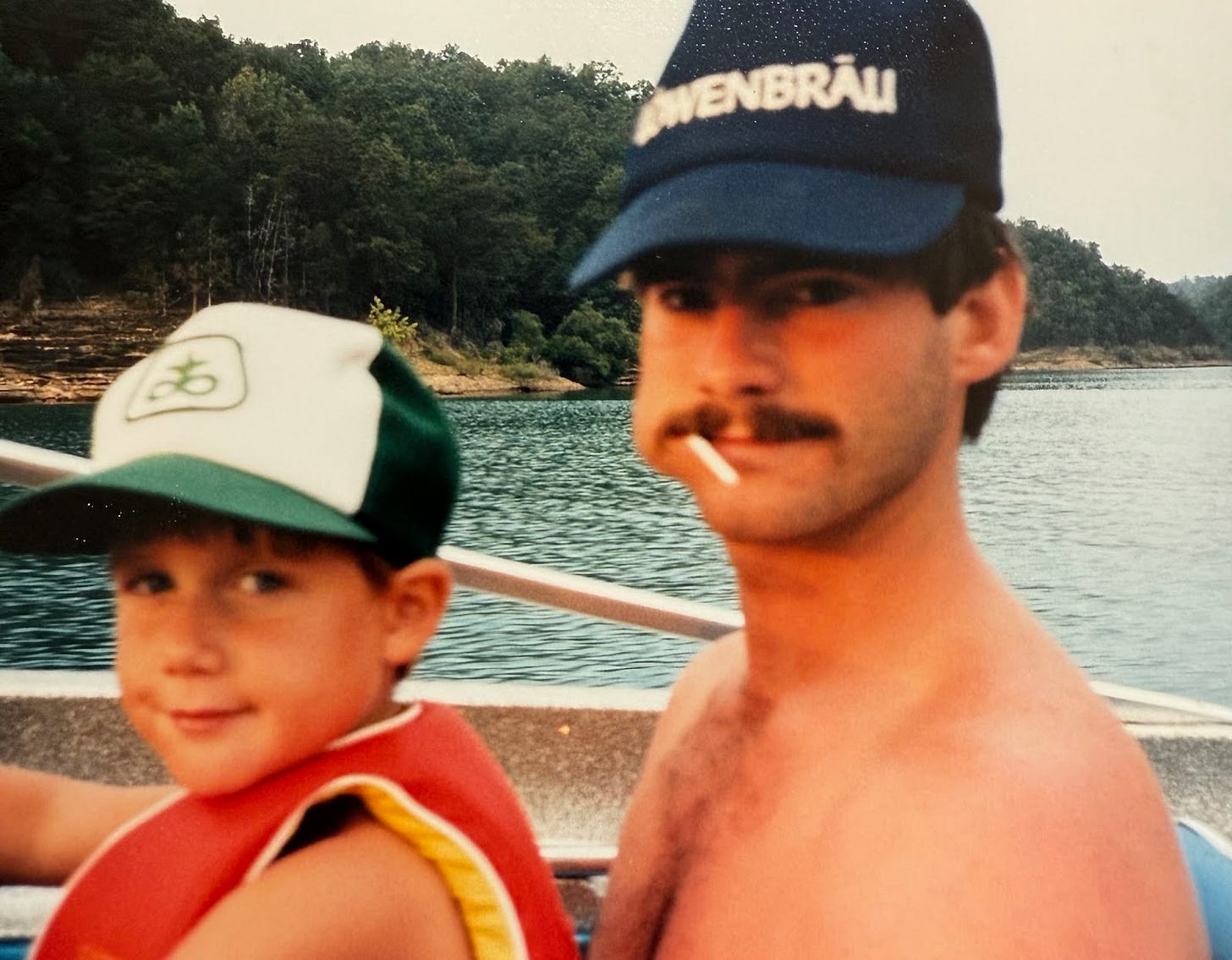 Man and child ride together on a boat at the lake, reflecting a close uncle-nephew relationship and the lasting impact of joyful family adventures and mentorship.